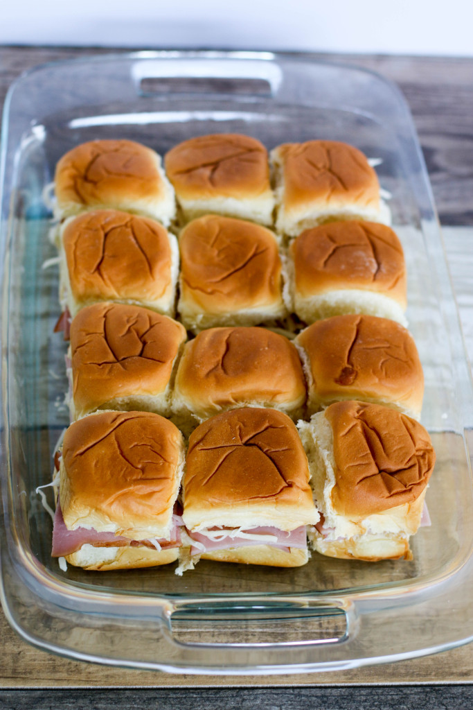 easy ham and cheese sliders in a clear glass casserole dish