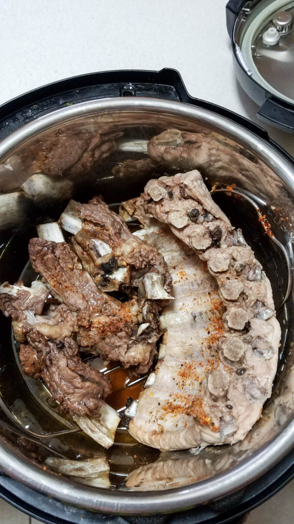 easy Instant pot ribs being cooked in a pressure cooker on a triveet