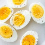 hard boiled eggs on a plate with salt and pepper