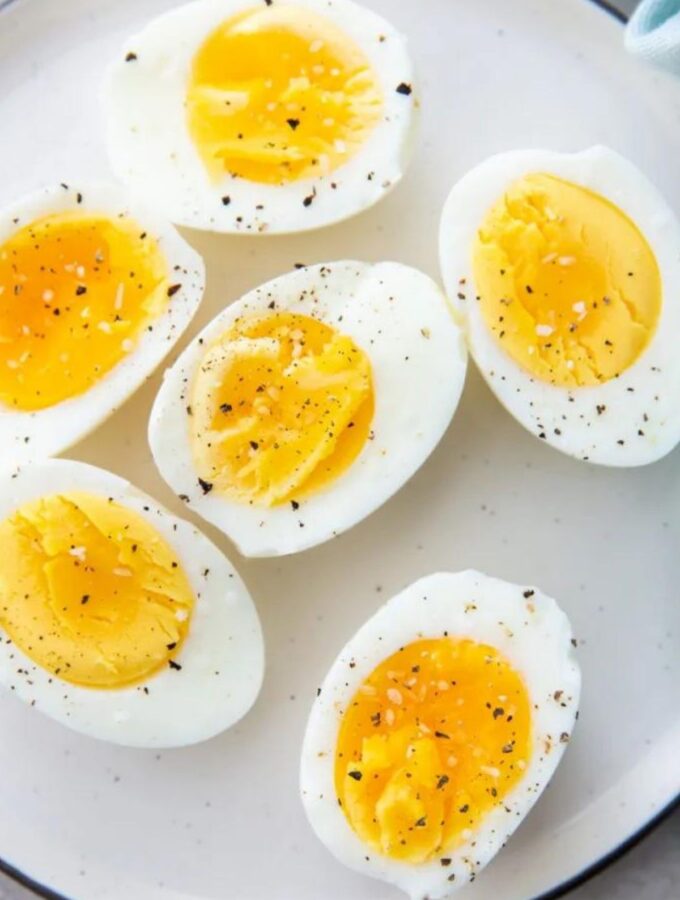 hard boiled eggs on a plate with salt and pepper