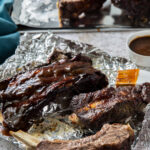 easy instant pot beef ribs cooked topped with low carb BBQ sauce on aluminum foil
