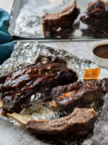 easy instant pot beef ribs cooked topped with low carb BBQ sauce on aluminum foil