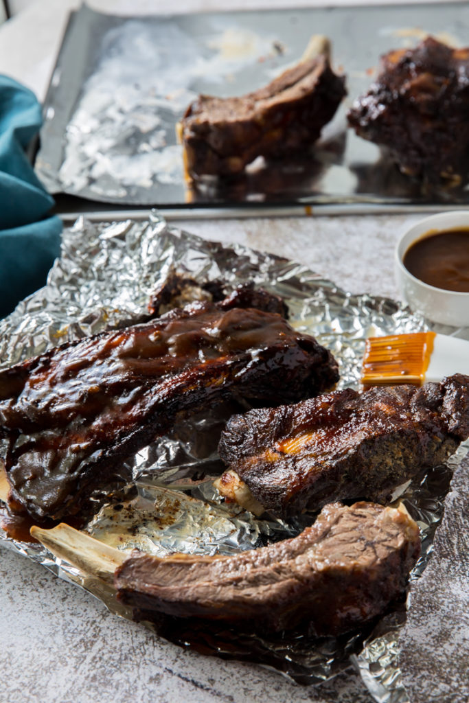 easy instant po beef ribs cooked topped with low carb BBQ sauce on aluminum foil