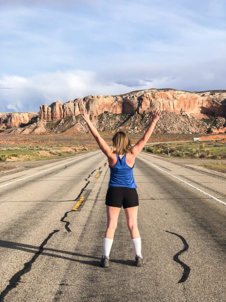 Lara in the middle of a deserted road in Utah