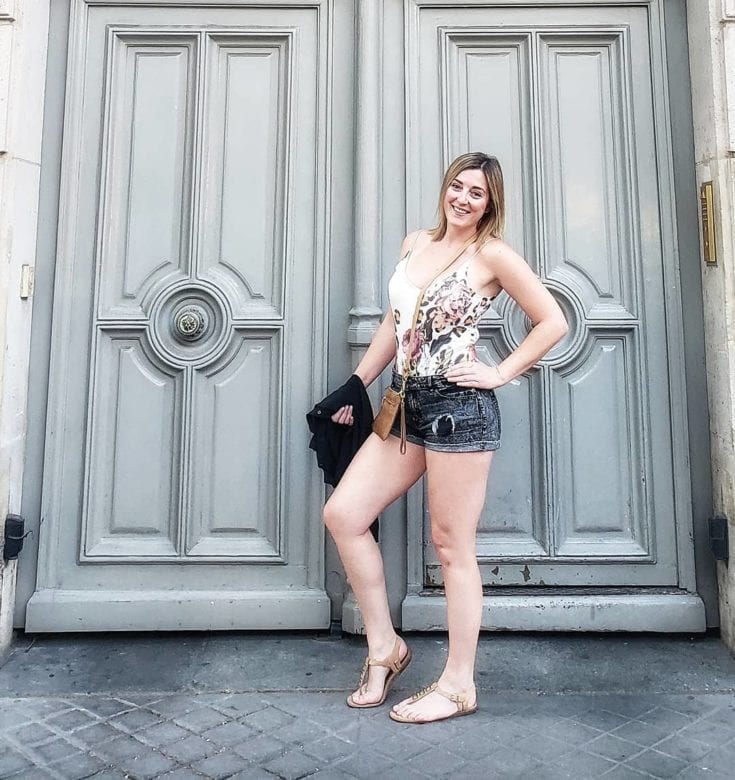 Lara in Paris Standing in front of a grey door