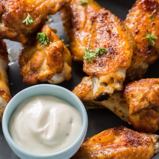 keto chicken wings on a plate with ranch topped with parsley