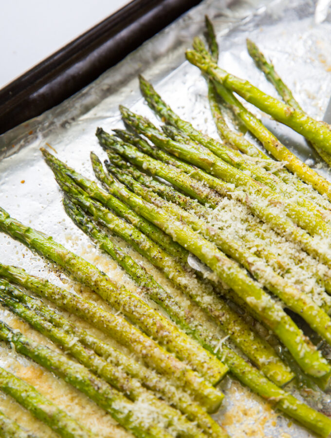 roasted garlic parmesan asparagus on a cookie sheet with aluminum foil