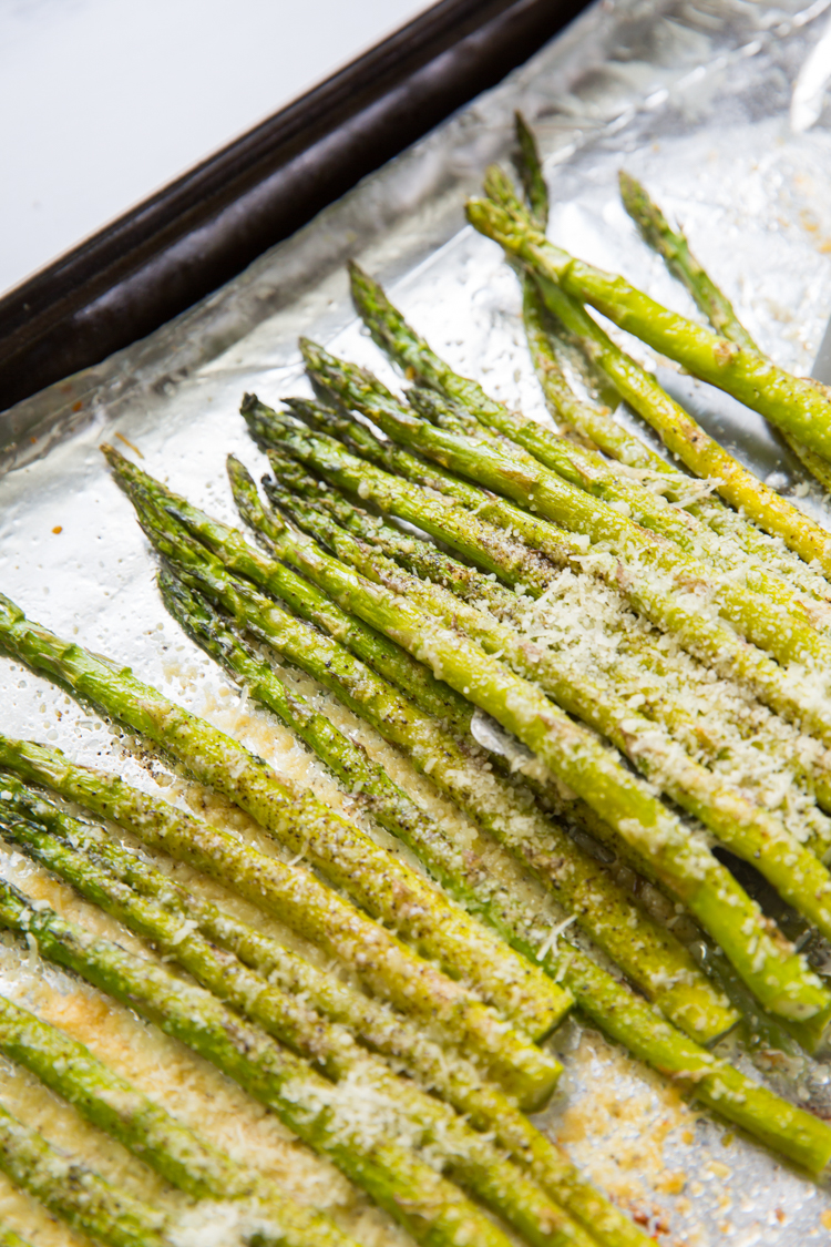roasted garlic parmesan asparagus on a cookie sheet with aluminum foil 