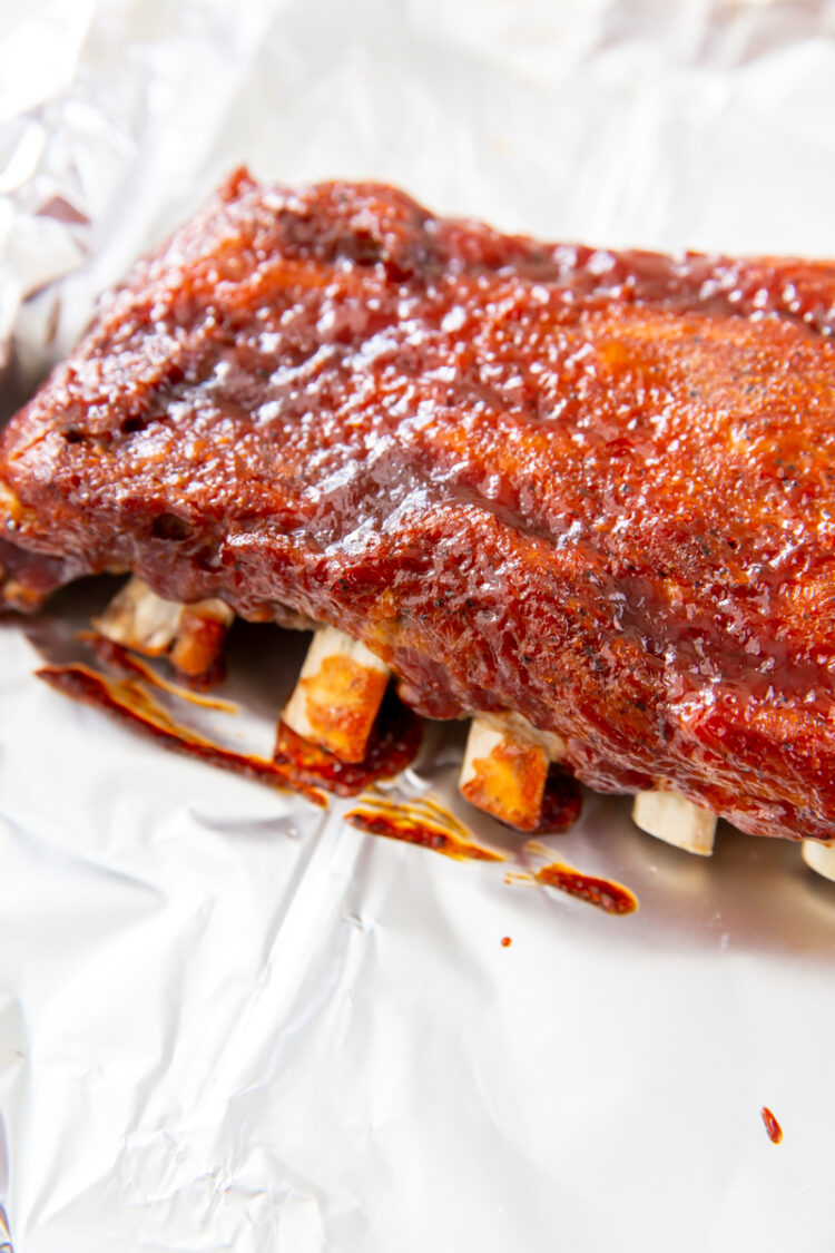 a rack of baby back ribs on aluminum foil