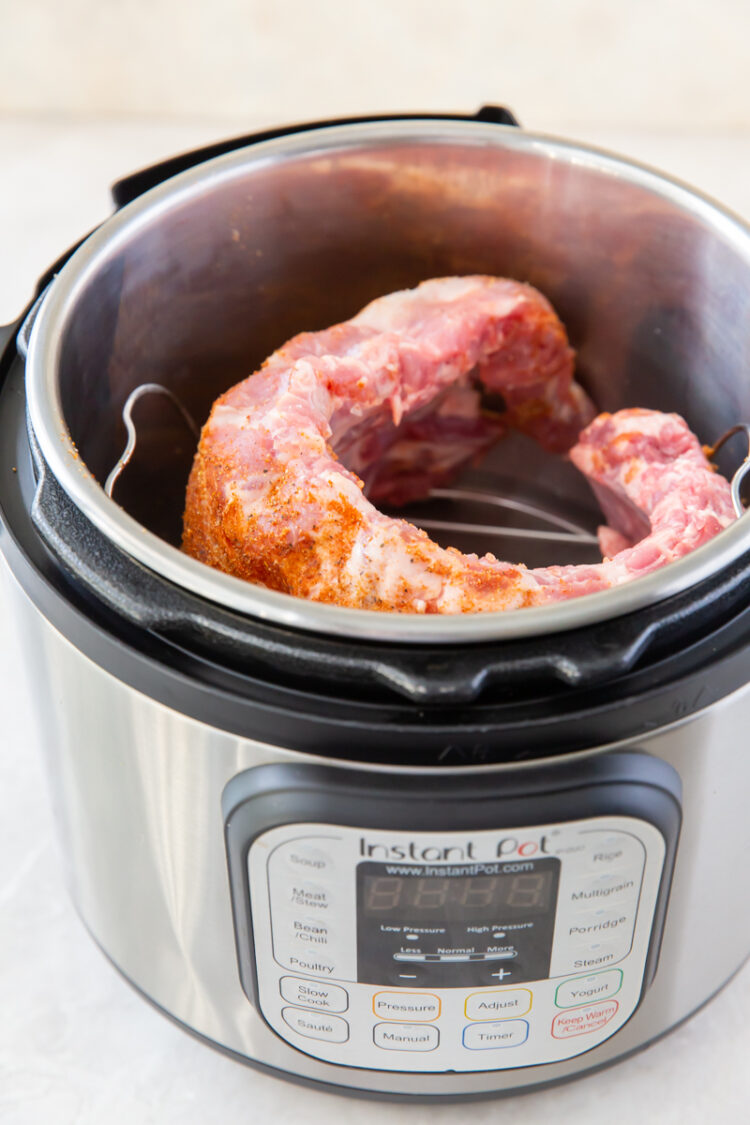 a raw rack of baby back ribs in an instant pot