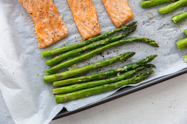 close up image of baked asparagus and salmon