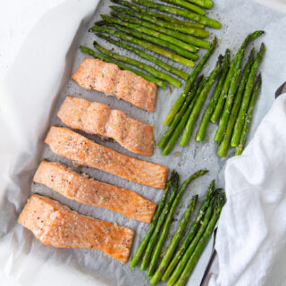 baked salmon and asparagus and a white cloth napkin