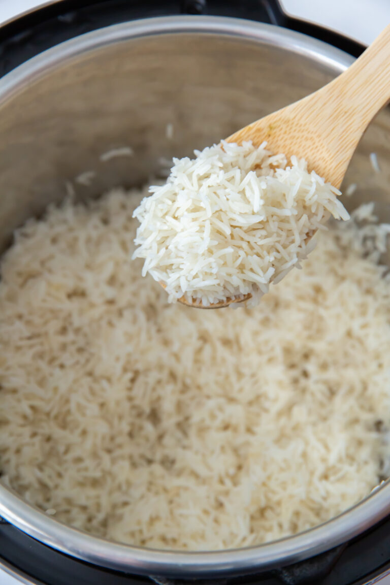 Instant Pot Basmati Rice in an Instant Pot with a wooden spoon.