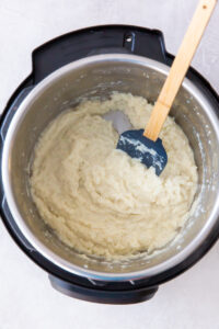 mashed cauliflower with a spatula inside an instant pot