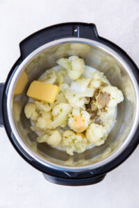 cauliflower, butter, cream and seasonings inside an instant pot