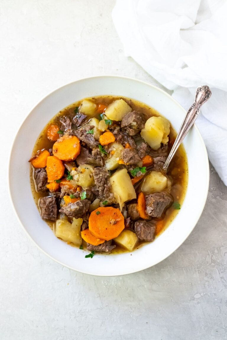 The Best Instant Pot Rump Roast Recipe on a white plate with potatoes, carrots and parsley.