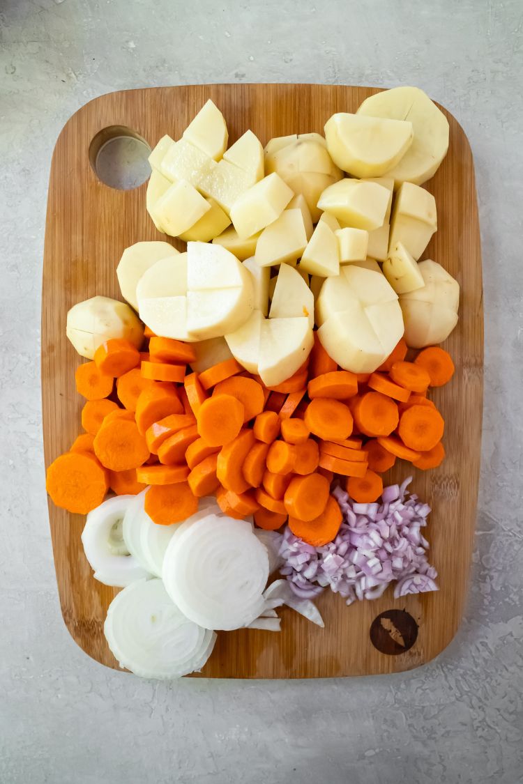 vegetables for a pot roast cut on a cutting board