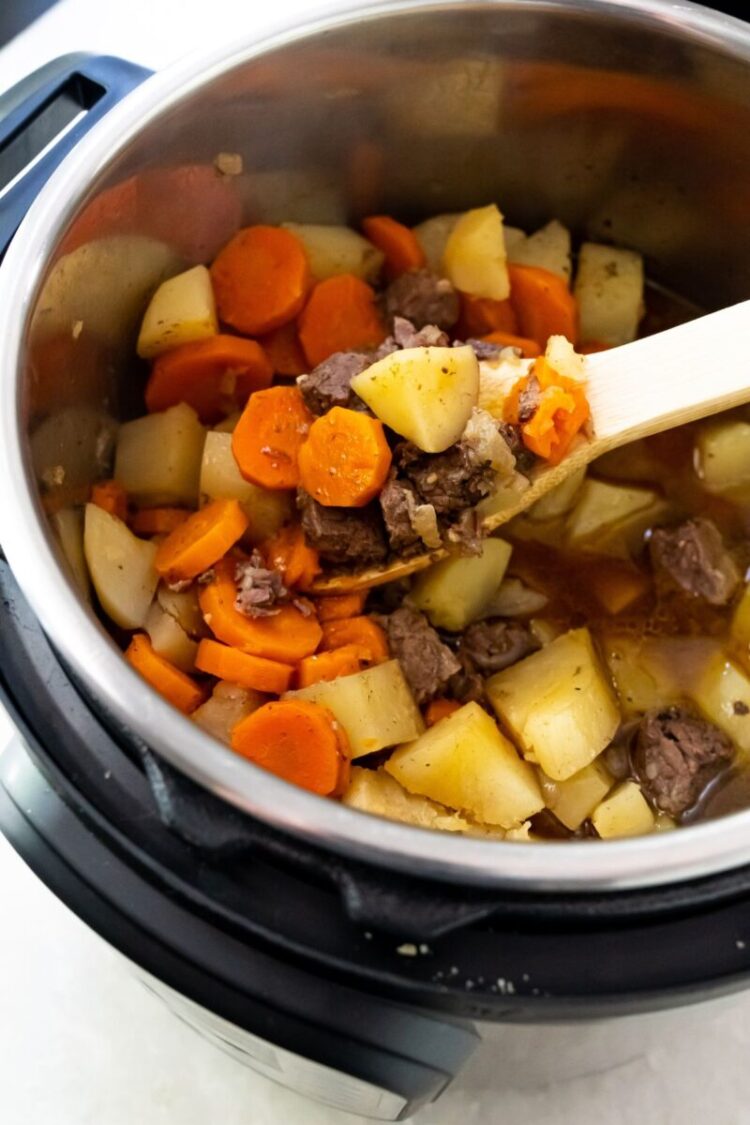 rump roast in a bowl with carrots and potatoes in an instant pot