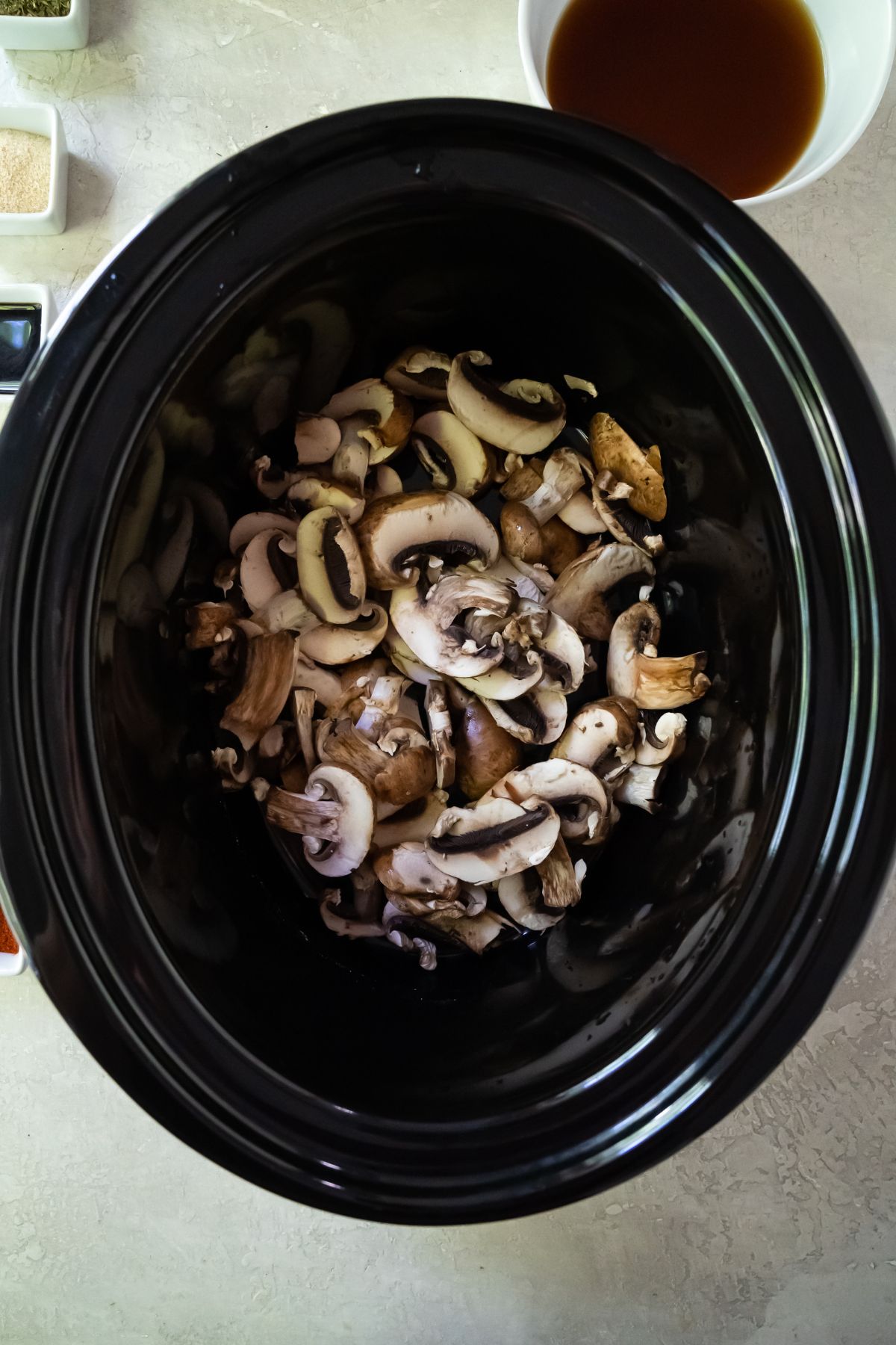 sliced mushrooms in a crockpot