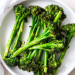 air fryer broccolini on a white plate