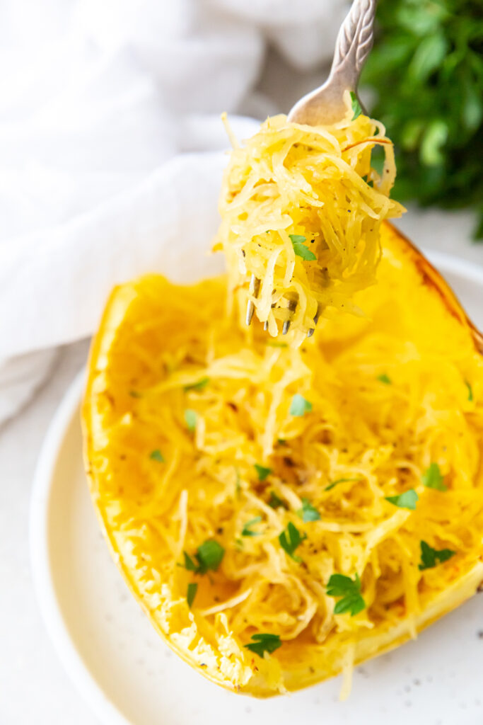 air fryer cooked spaghetti squash with a fork and white napkin