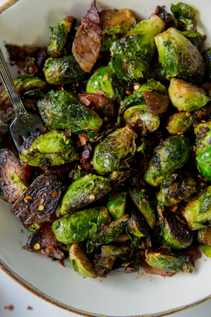 close up of Brussels sprouts with bacon in a bowl