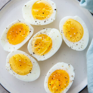air fryer eggs on a white plate with a blue napkin