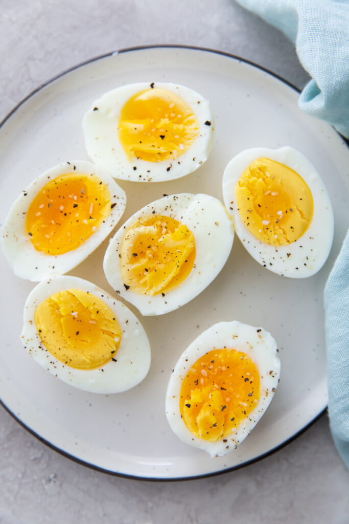 air fryer eggs on a white plate with a blue napkin