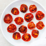 roasted tomatoes topped with salt, pepper and garlic