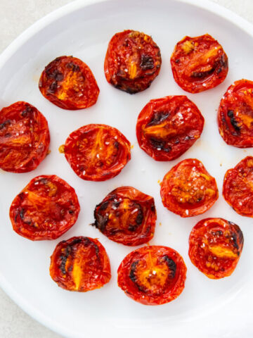 roasted tomatoes topped with salt, pepper and garlic