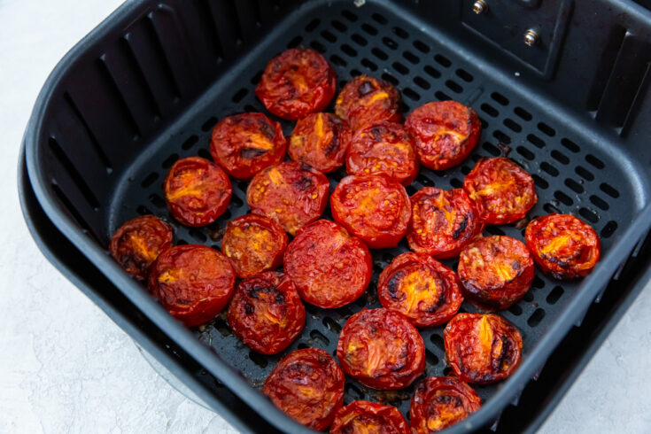 roasted tomatoes in an air fryer basket