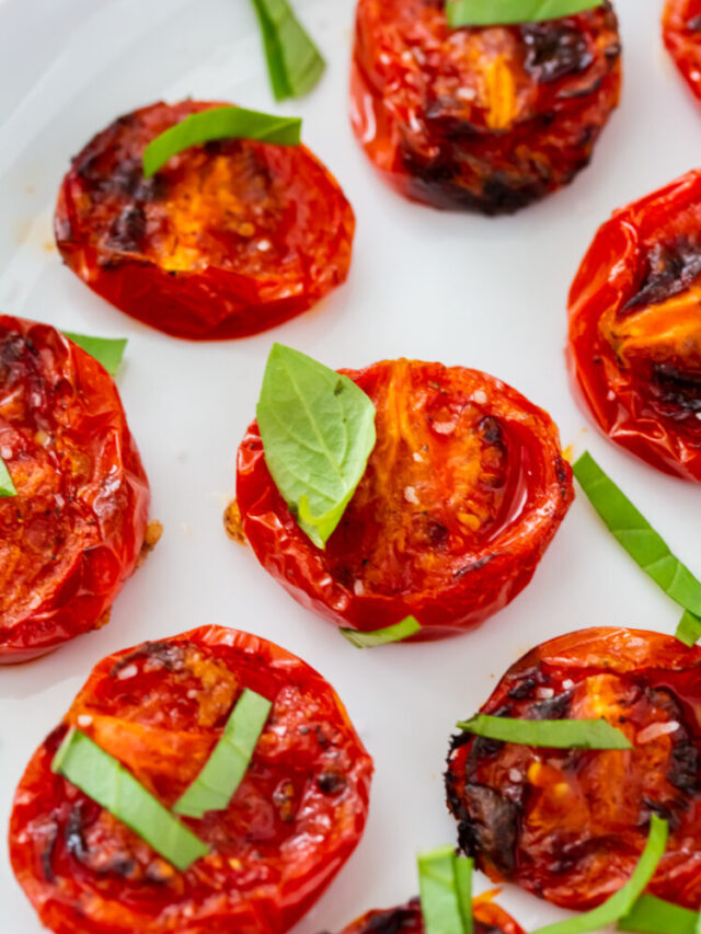 roasted tomatoes topped with fresh basil, salt, pepper and garlic