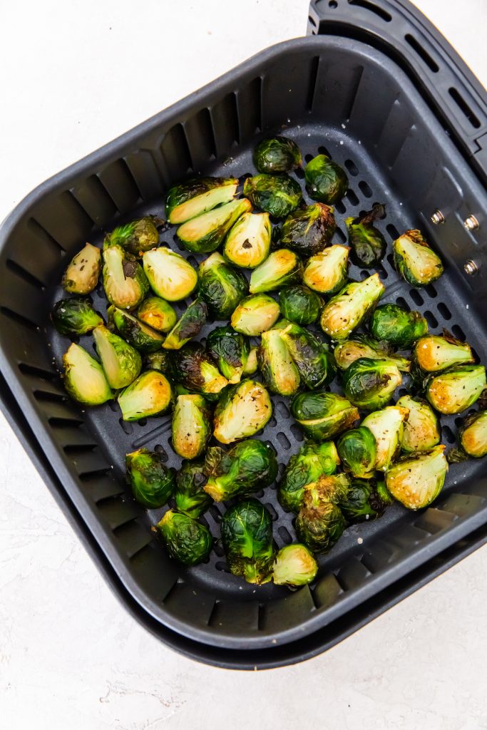 cooked Brussel sprouts in an air fryer basket