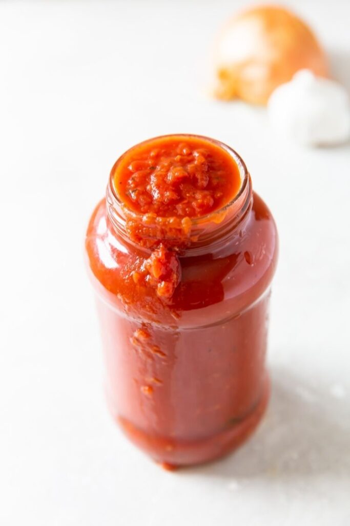 keto spaghetti sauce in a glass jar on a white background