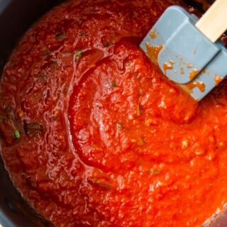 Keto spaghetti sauce in a saucepan with a spatula