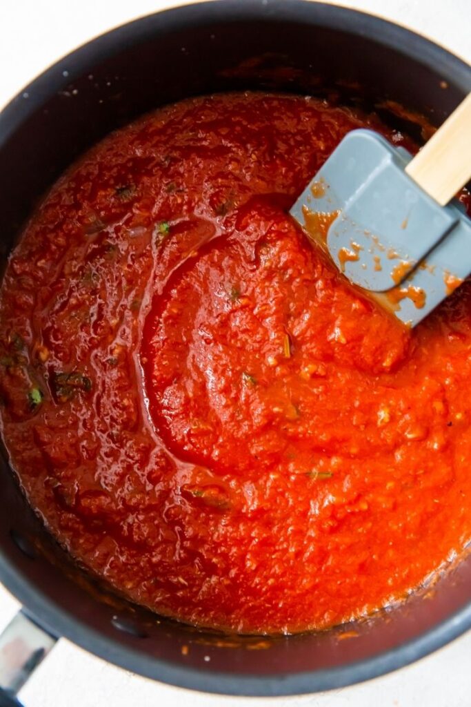 Keto spaghetti sauce in a saucepan with a spatula