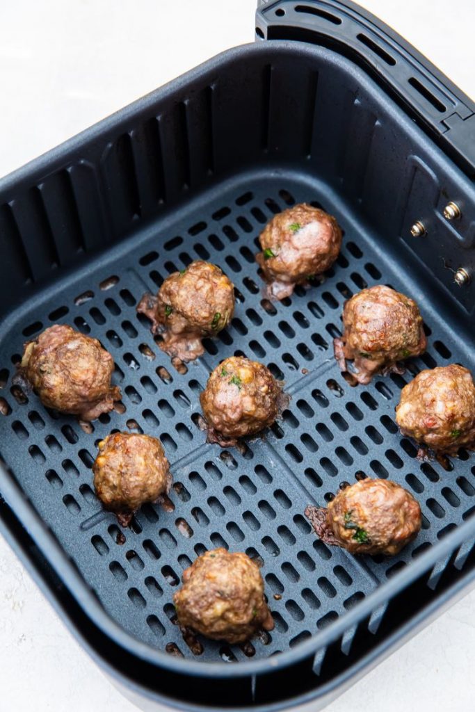 cooked keto meatballs in an air fryer basket