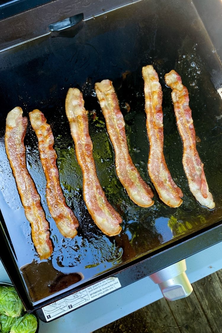 bacon being cooked on a Blackstone Griddle