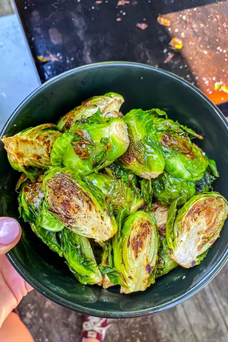 cooked brussel sprouts in a black bowl