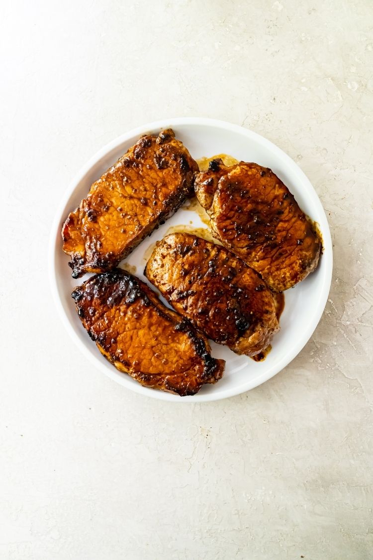 Griddled pork chops on a white plate