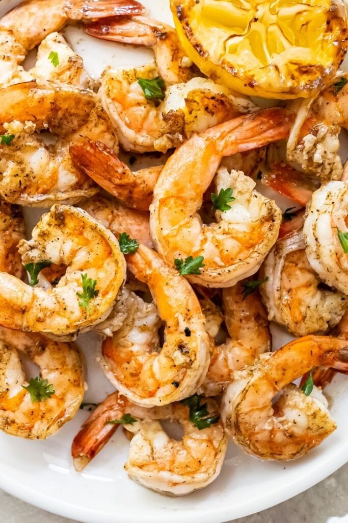 close up image of grilled shrimp topped with parsley