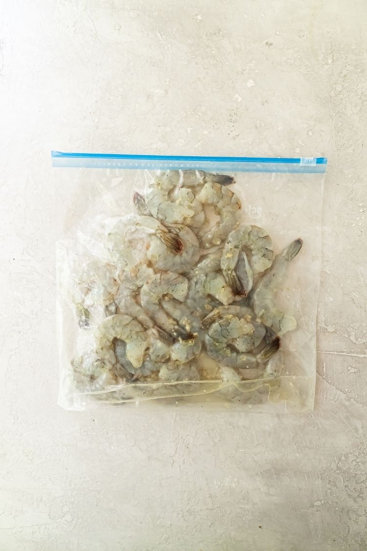 raw shrimp marinating in a bag with oil and seasoning