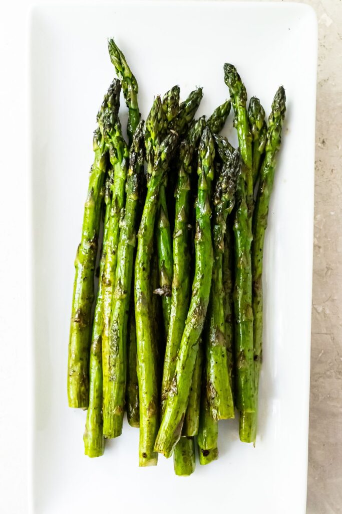 Grilled asparagus on a white plate