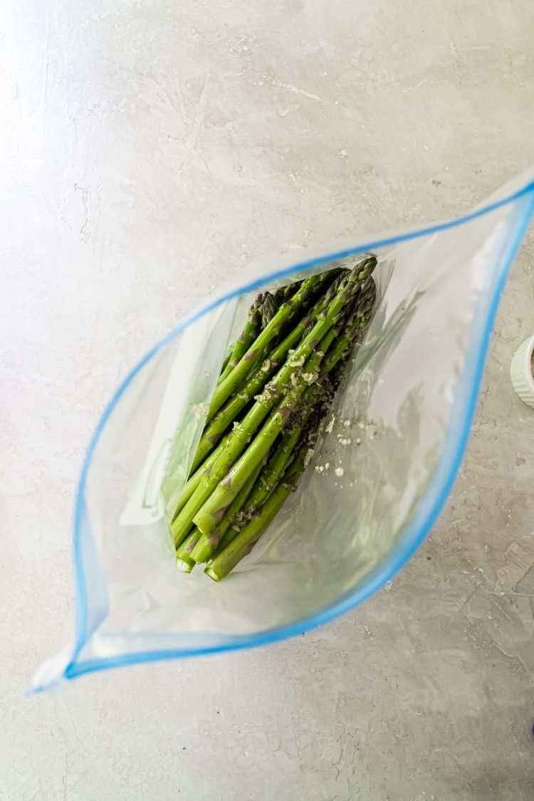 fresh asparagus in a bag with oil and spices