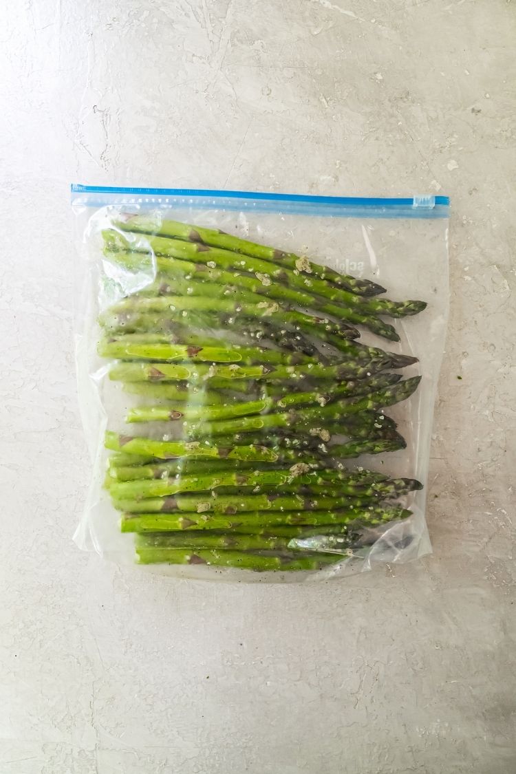 fresh asparagus in a bag with oil and spices