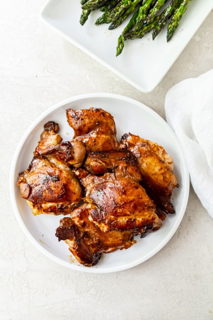 teriyaki grilled chicken thighs on a white plate