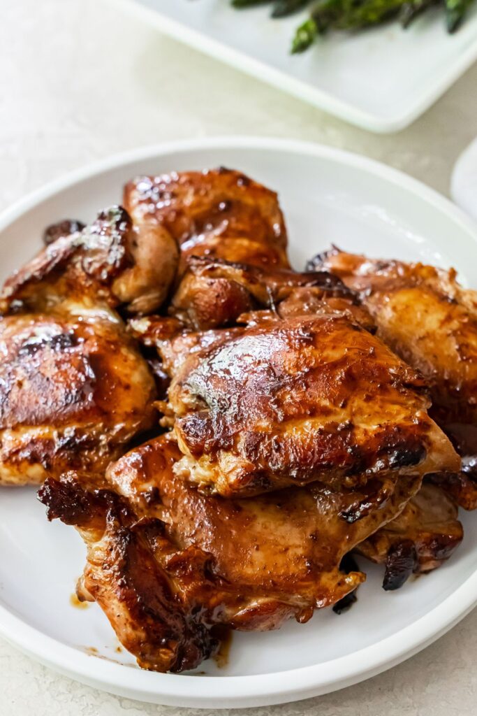 teriyaki grilled chicken thighs on a white plate