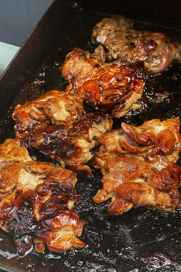 teriyaki chicken thighs cooking on a Blackstone Griddle