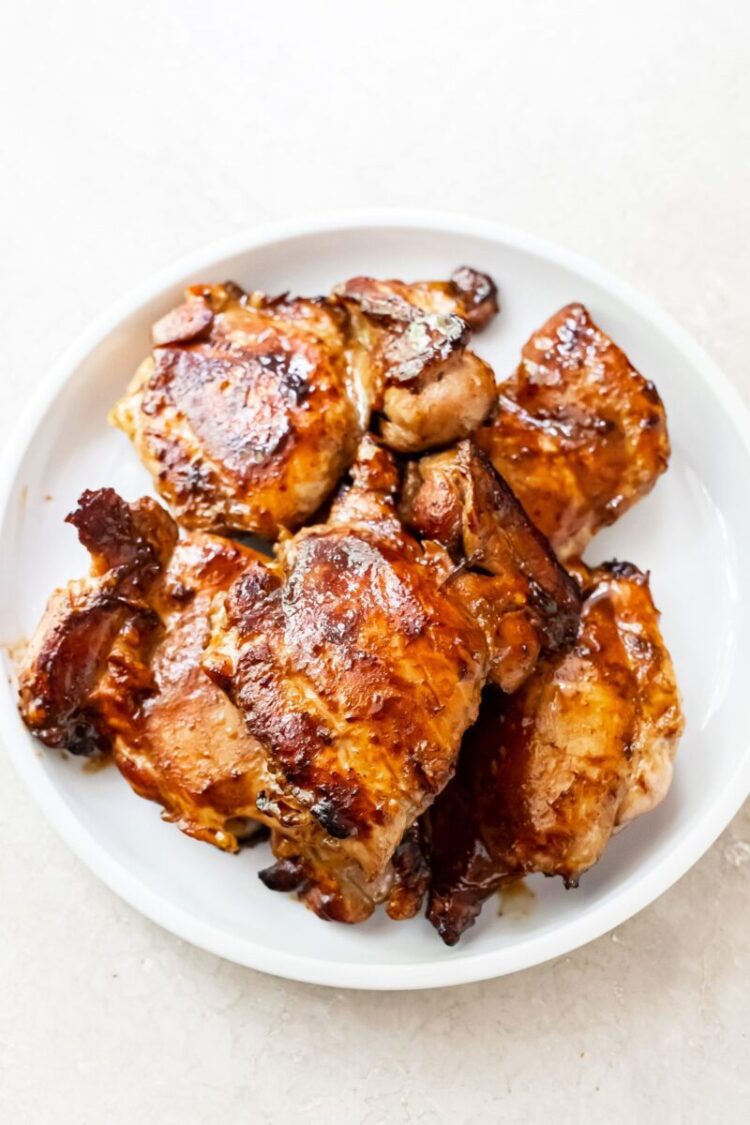 teriyaki grilled chicken thighs on a white plate