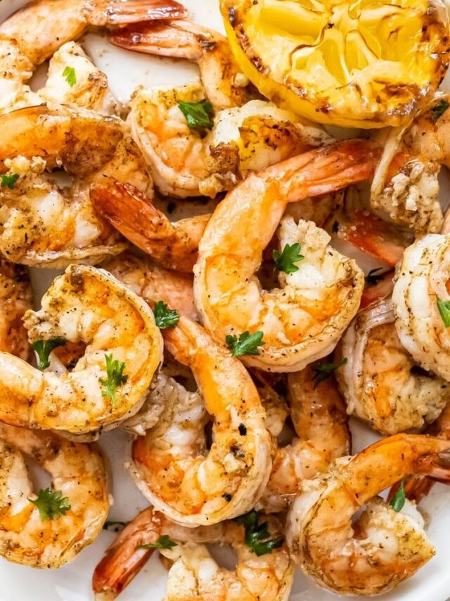 close up image of grilled shrimp topped with parsley